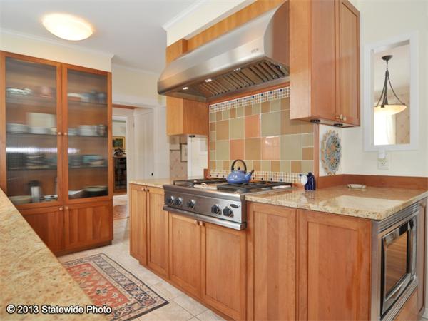 452 Highland Road Tiverton, RI 02878 - Photo 8 of 26 a kitchen with stainless steel appliances granite countertop a stove a sink and a microwave