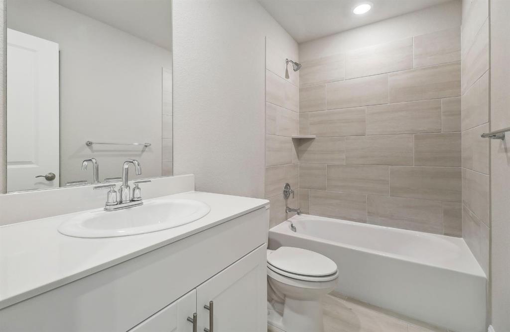 503 Stagg Street McKinney, TX 75069 - Photo 14 of 19 a bathroom with a sink a toilet and a bathtub