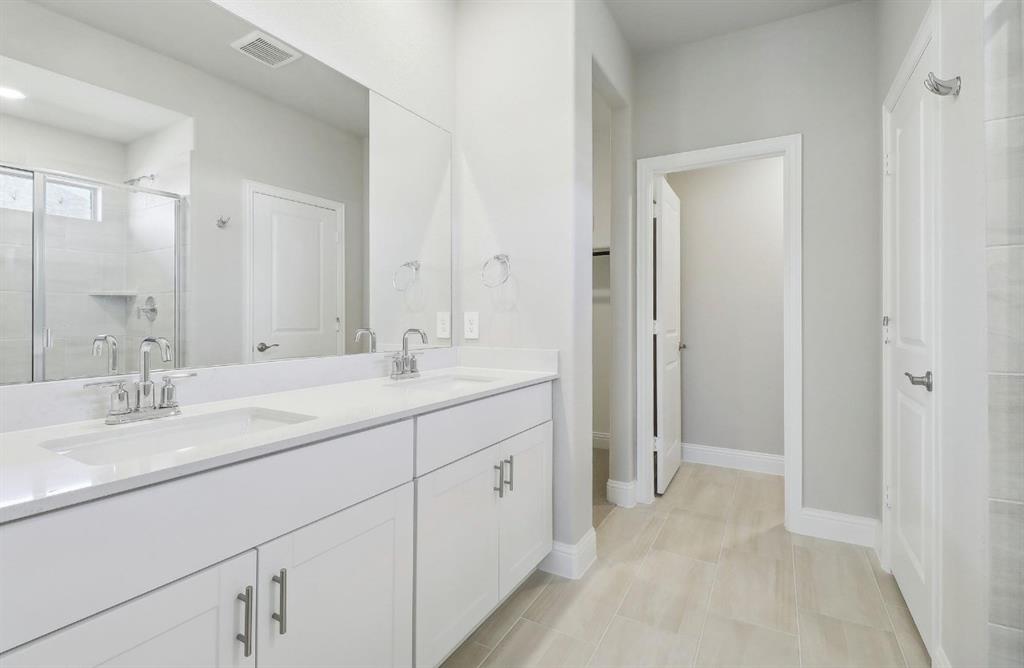 503 Stagg Street McKinney, TX 75069 - Photo 17 of 19 a spacious bathroom with a double vanity sink mirror and double