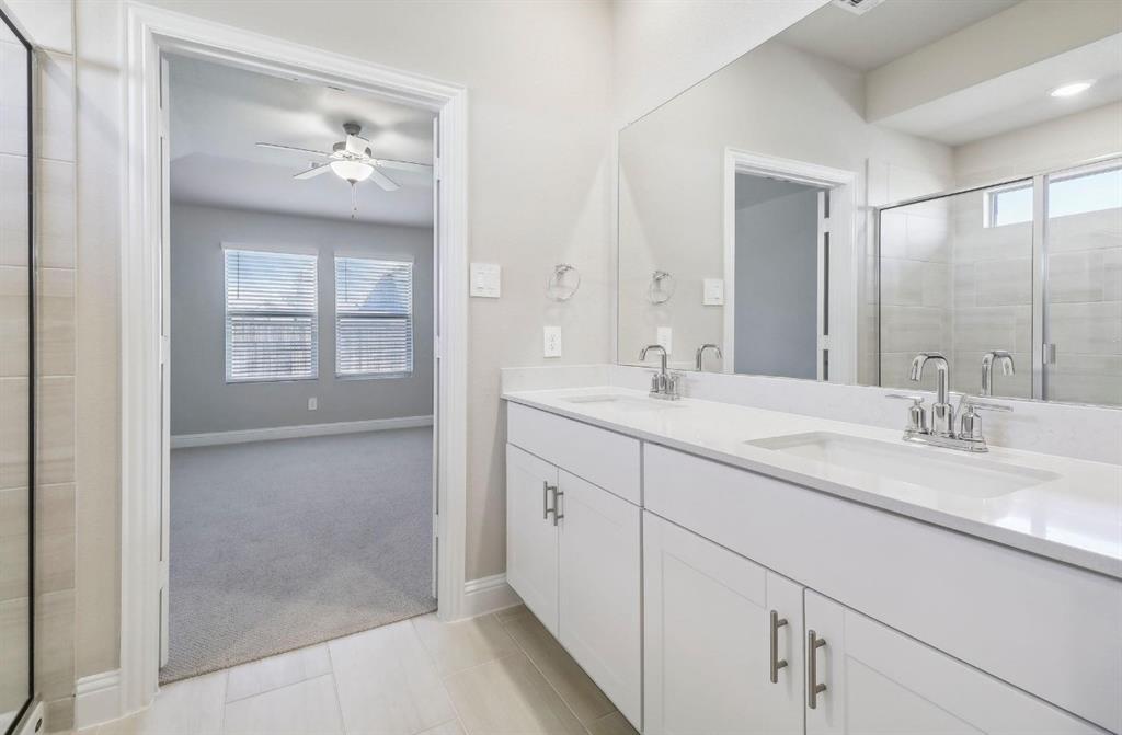 503 Stagg Street McKinney, TX 75069 - Photo 18 of 19 a bathroom with double vanity sink and a mirror