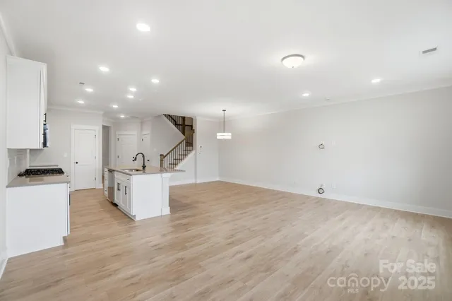 a view of a hallway with wooden floor and entryway