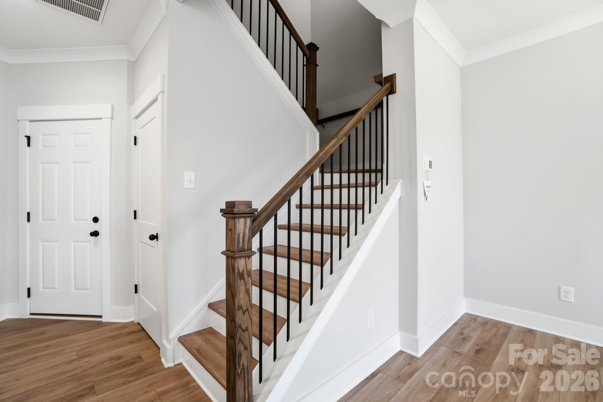 410 Limelight Road Waxhaw, NC 28173 - Photo 13 of 27 a view of a hallway with wooden floor and entryway