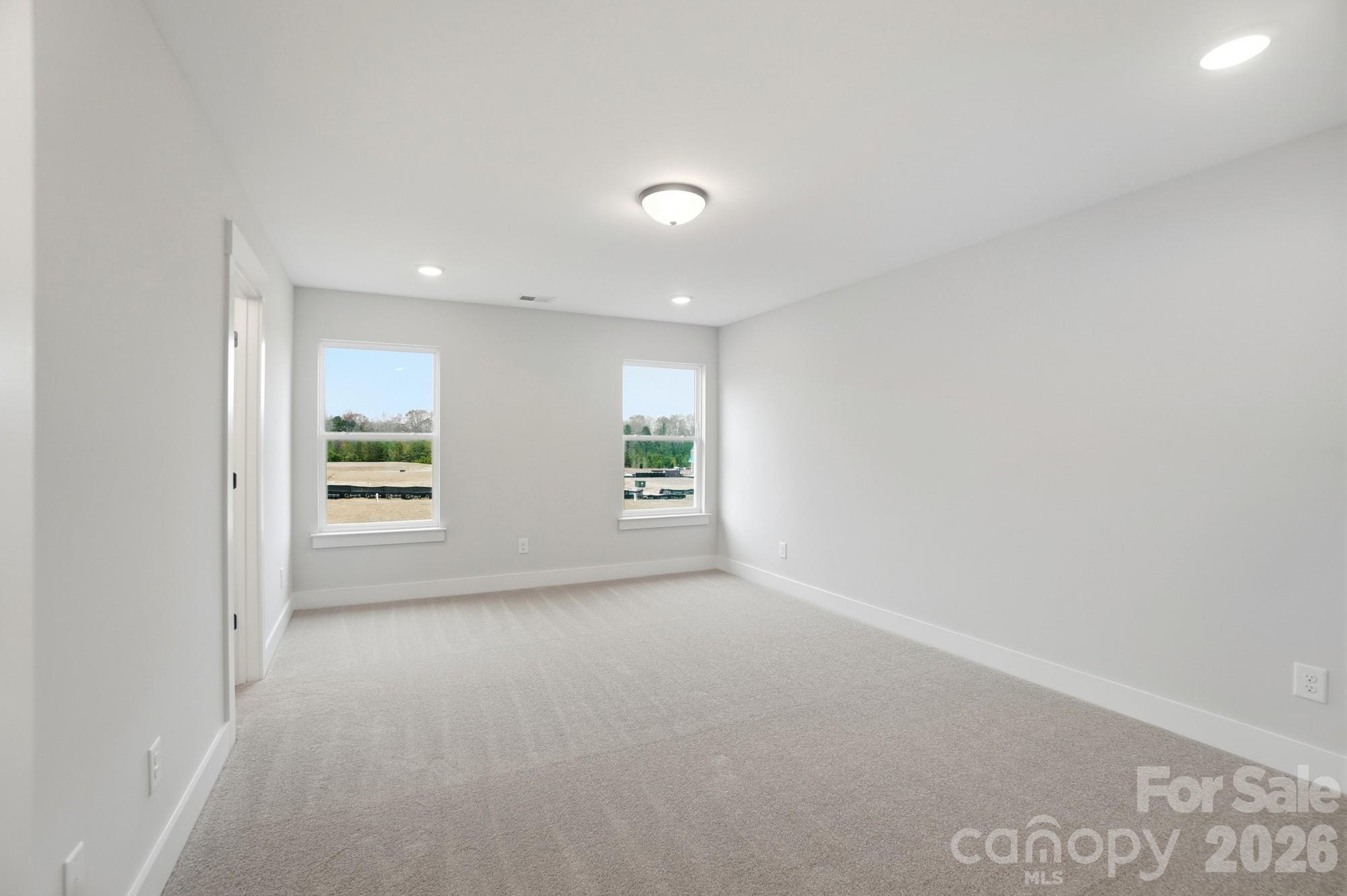 410 Limelight Road Waxhaw, NC 28173 - Photo 17 of 27 an empty room with windows