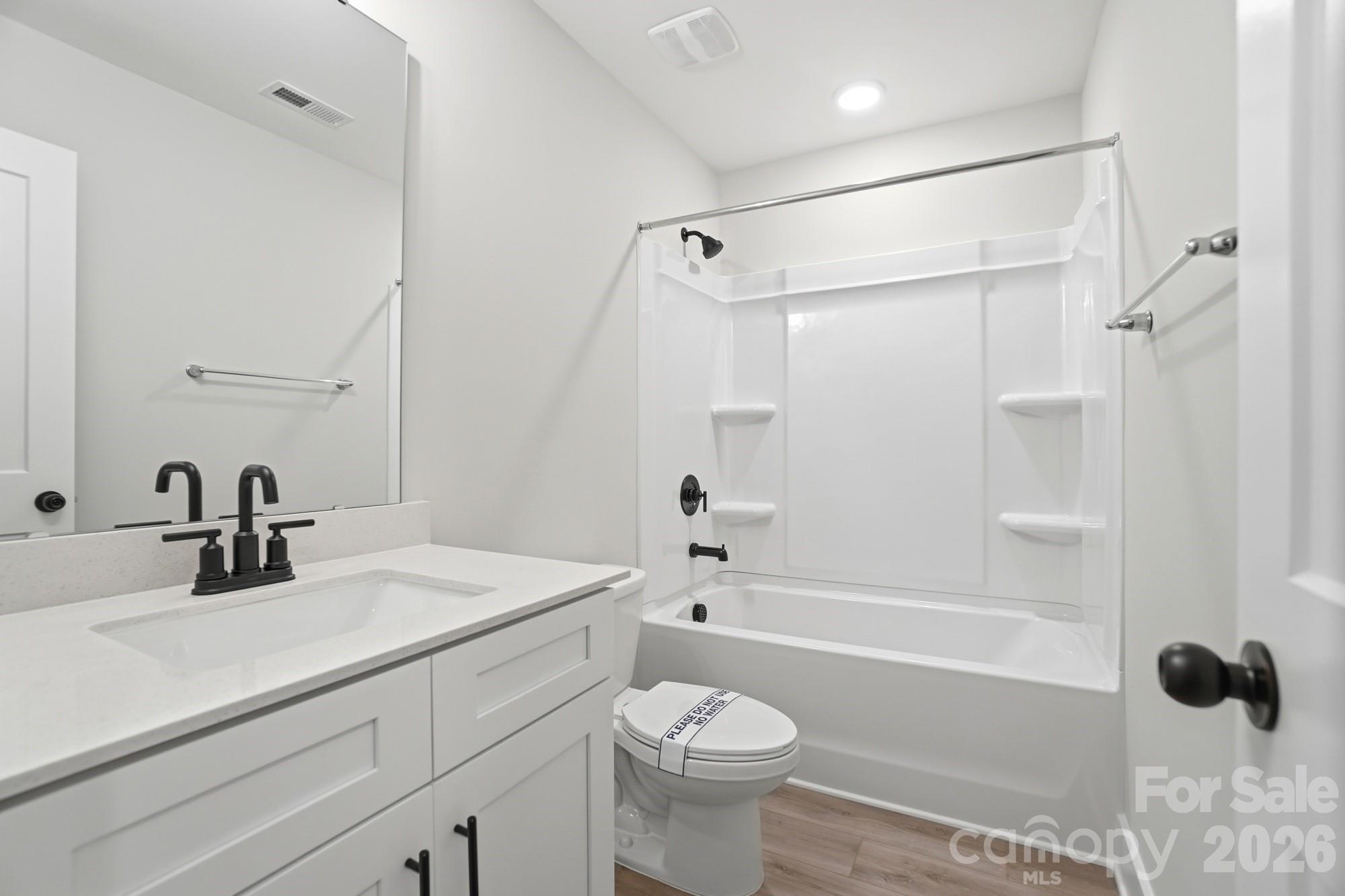 410 Limelight Road Waxhaw, NC 28173 - Photo 23 of 27 a bathroom with a sink toilet vanity and shower