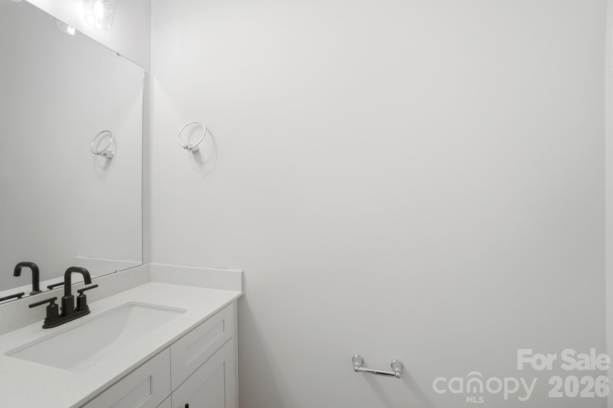 410 Limelight Road Waxhaw, NC 28173 - Photo 4 of 27 a bathroom with a sink and mirror