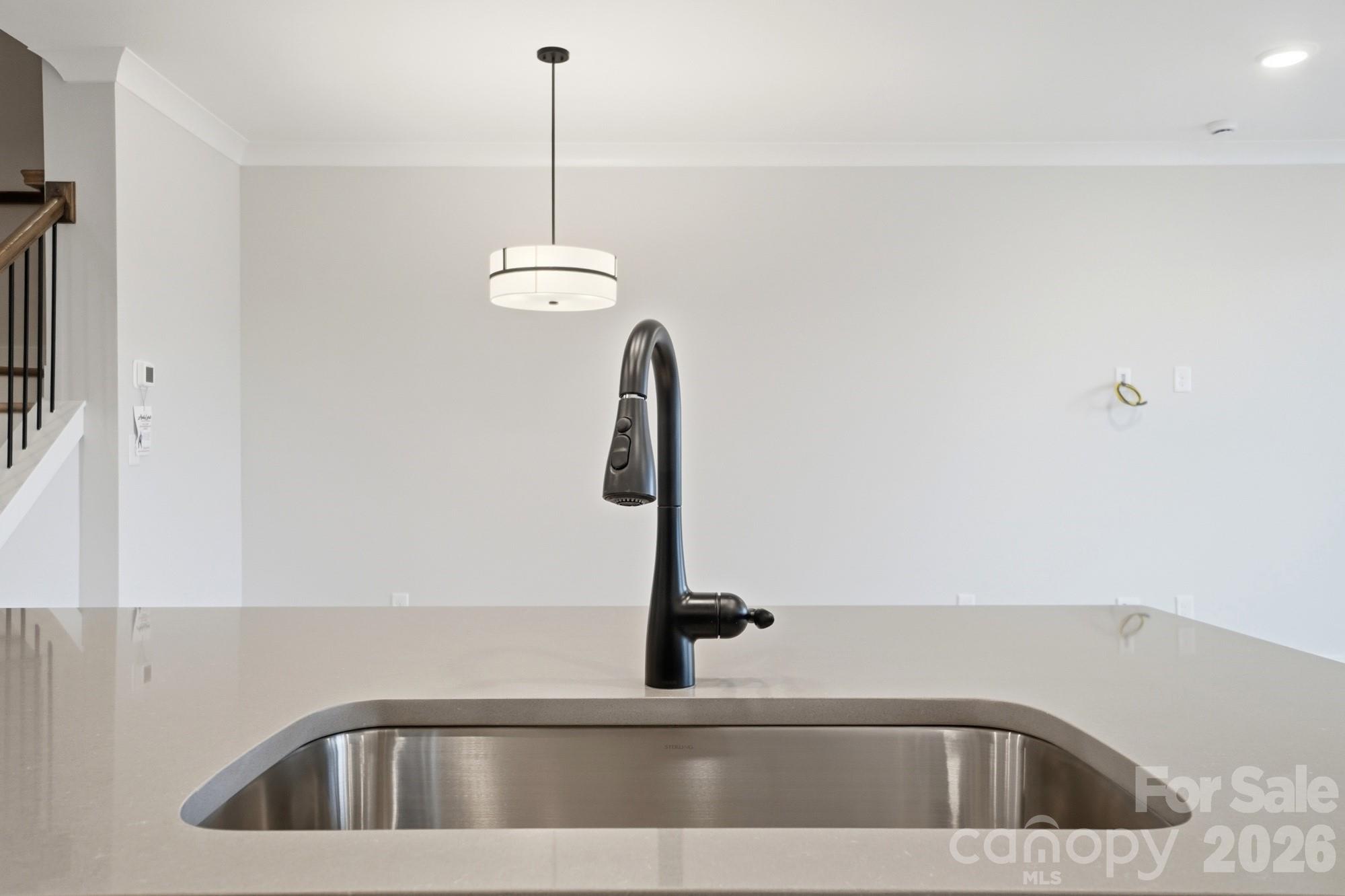 410 Limelight Road Waxhaw, NC 28173 - Photo 8 of 27 a kitchen with a sink and chandelier