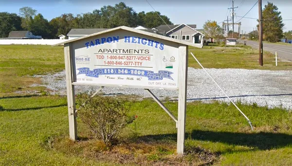 a sign on the side of the river