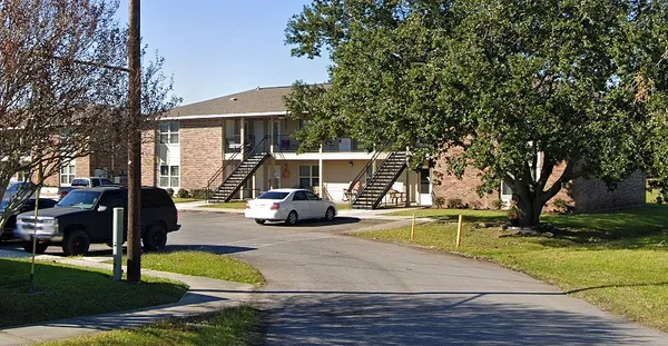 a view of a house with entertaining space and a tree