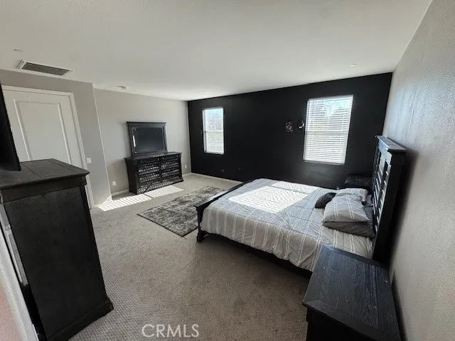 a bedroom with a bed and a television