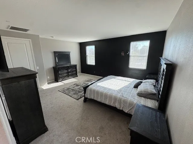 a bedroom with a bed and a television