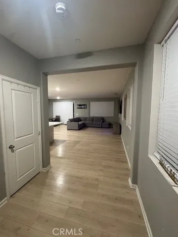 a view of kitchen with refrigerator and window
