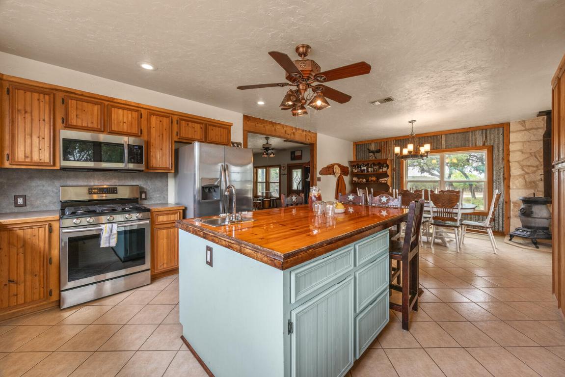 3487 Rust Spring Branch, TX 78070 - Photo 11 of 40 a kitchen with stainless steel appliances granite countertop a sink stove and cabinets