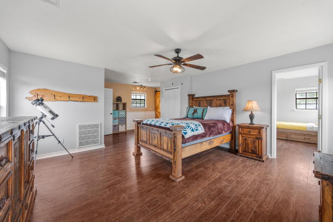 3487 Rust Spring Branch, TX 78070 - Photo 17 of 40 a bedroom with a bed and a chandelier