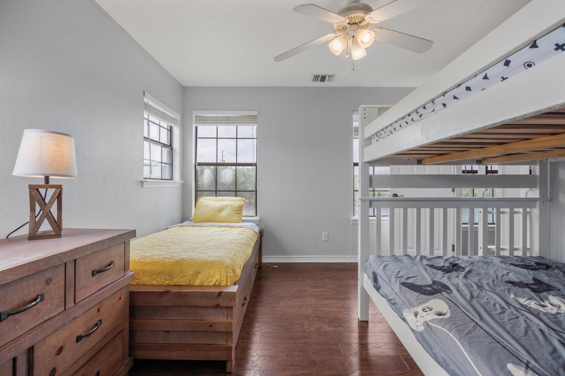 3487 Rust Spring Branch, TX 78070 - Photo 19 of 40 a bedroom with a bed and a chandelier