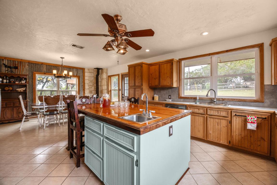 3487 Rust Spring Branch, TX 78070 - Photo 10 of 40 a kitchen with stainless steel appliances granite countertop sink stove and cabinets