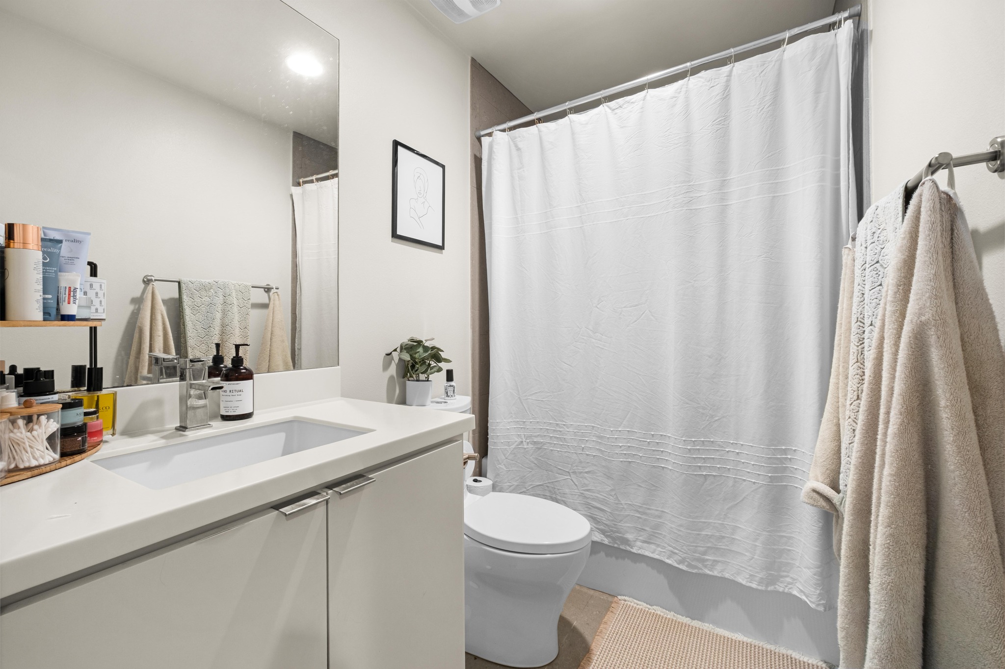 2802 Warren Street, Unit B Austin, TX 78703 - Photo 15 of 23 Bathroom featuring a single vanity with integrated sink, chrome faucet, and white countertop