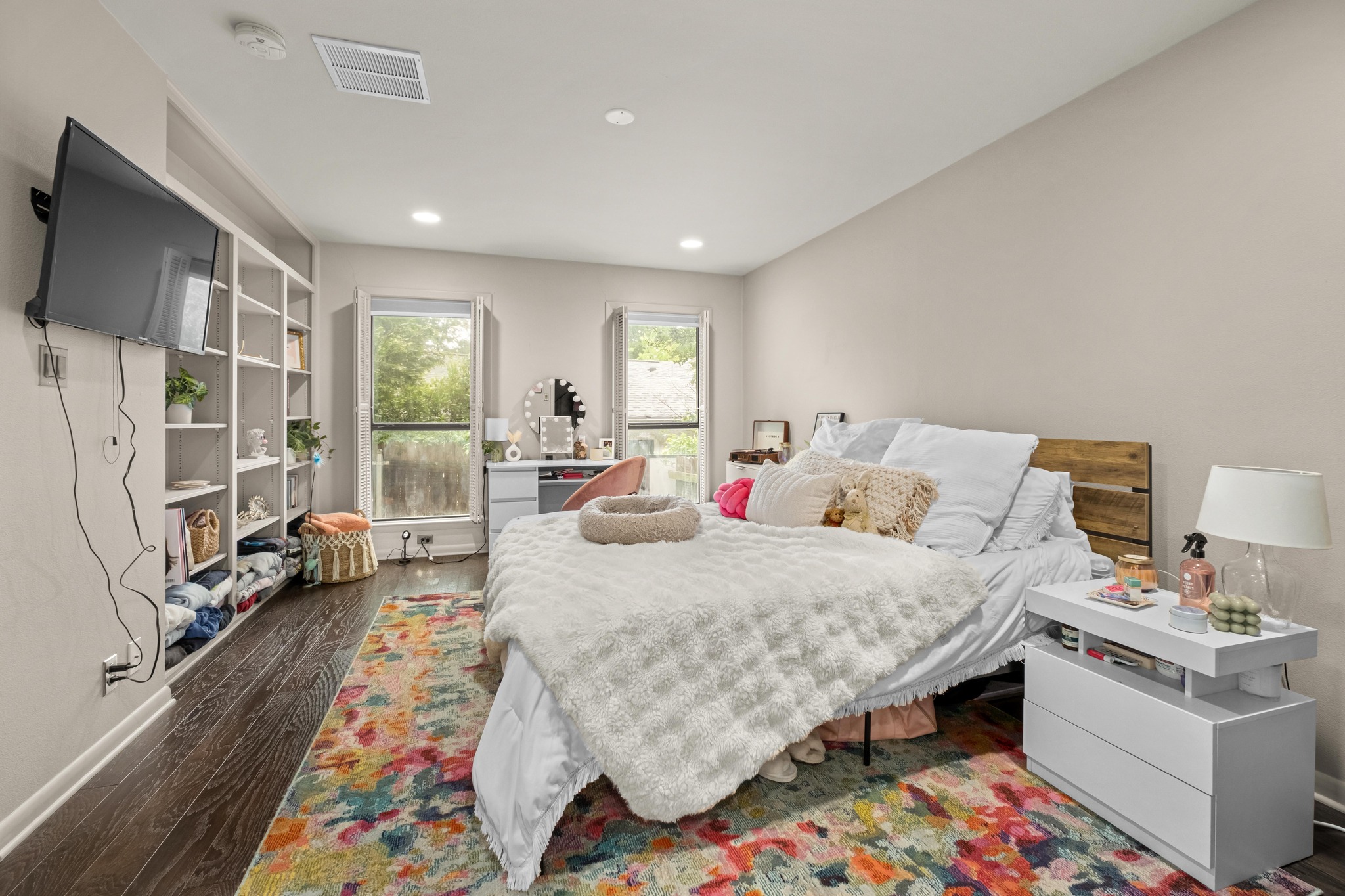 2802 Warren Street, Unit B Austin, TX 78703 - Photo 16 of 23 Bedroom featuring wood-finish flooring, two windows, recessed lighting, and built-in shelving