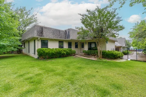 a view of a house with a backyard and a patio