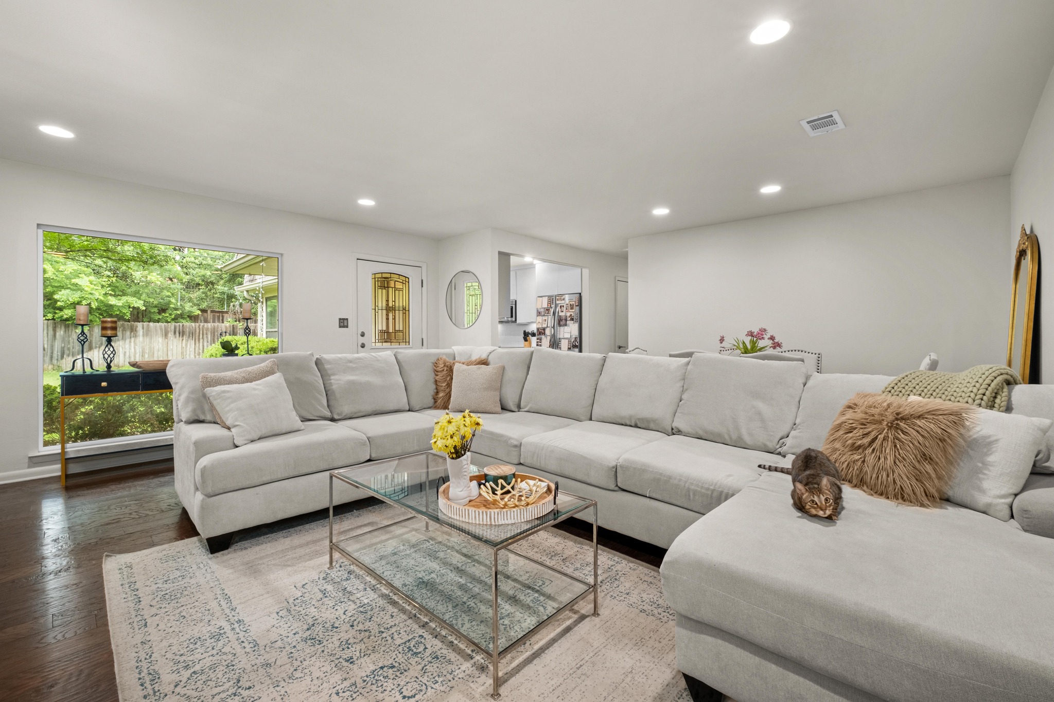 2802 Warren Street, Unit B Austin, TX 78703 - Photo 4 of 23 Spacious living area featuring dark wood-finish flooring, recessed lighting, and a large picture window