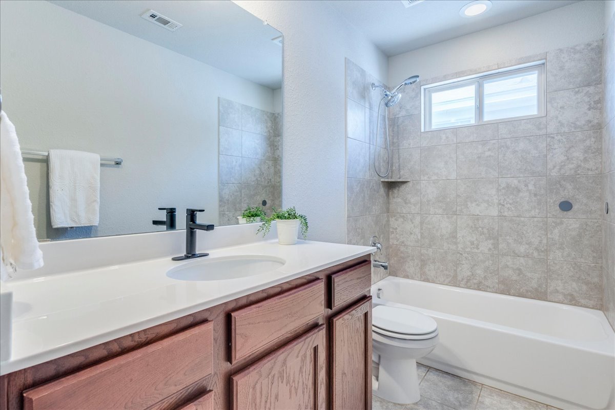 312 Triumph Road Buda, TX 78610 - Photo 30 of 36 a bathroom with a sink a toilet and shower