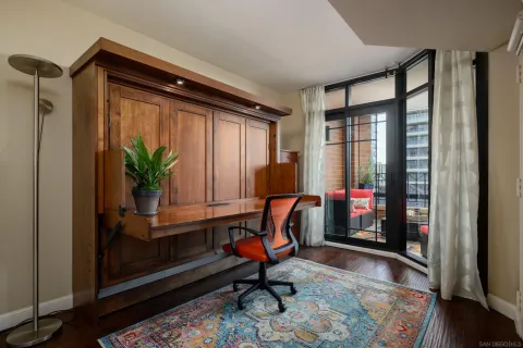 a living room with furniture and floor to ceiling windows