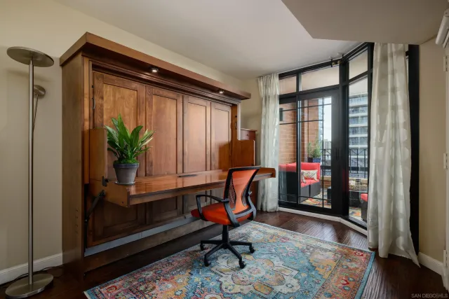 a living room with furniture and floor to ceiling windows