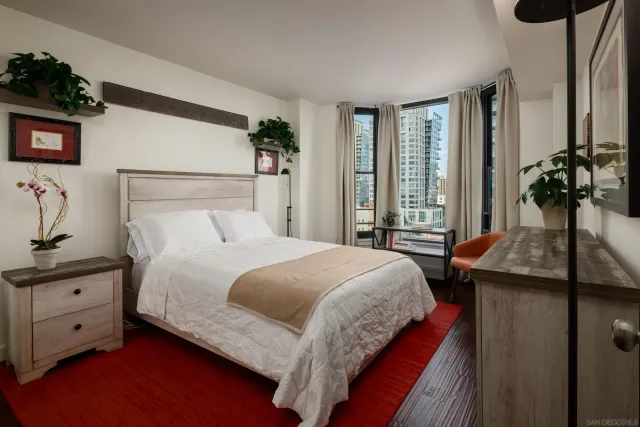 a bedroom with a bed and a large mirror