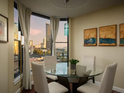 a dining room with furniture and a window