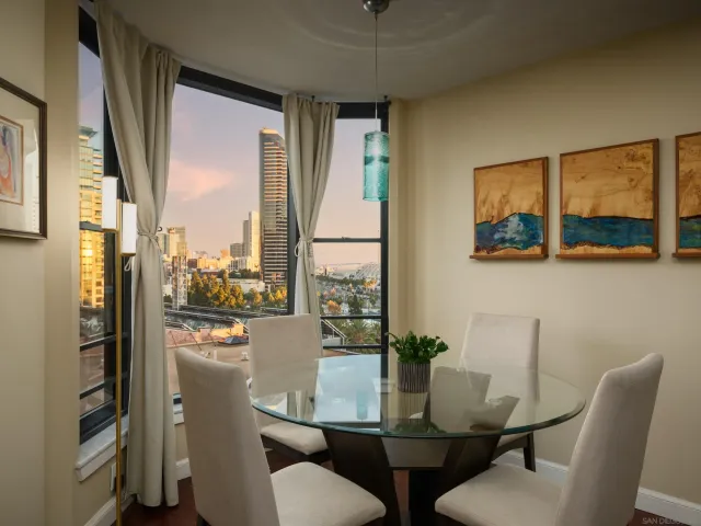a dining room with furniture and a window