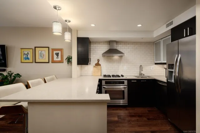 a kitchen with stainless steel appliances a sink and a refrigerator