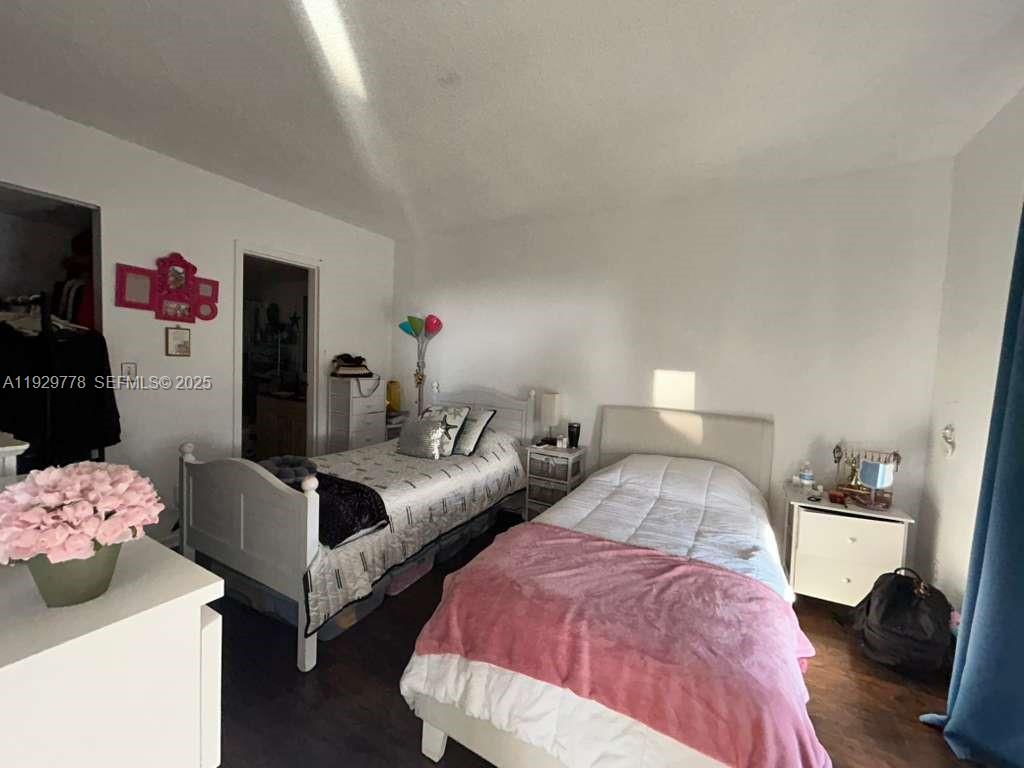 13499 Biscayne Boulevard, Unit 1206 North Miami, FL 33181 - Photo 12 of 20 a bedroom with two beds and closet