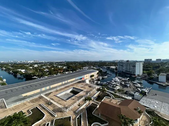 an aerial view of a residential building with parking space