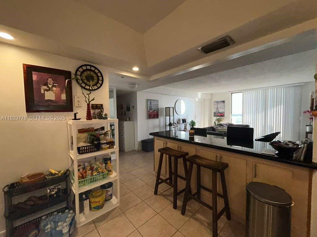 13499 Biscayne Boulevard, Unit 1206 North Miami, FL 33181 - Photo 6 of 20 a room with stainless steel appliances a stove a sink a refrigerator and cabinets