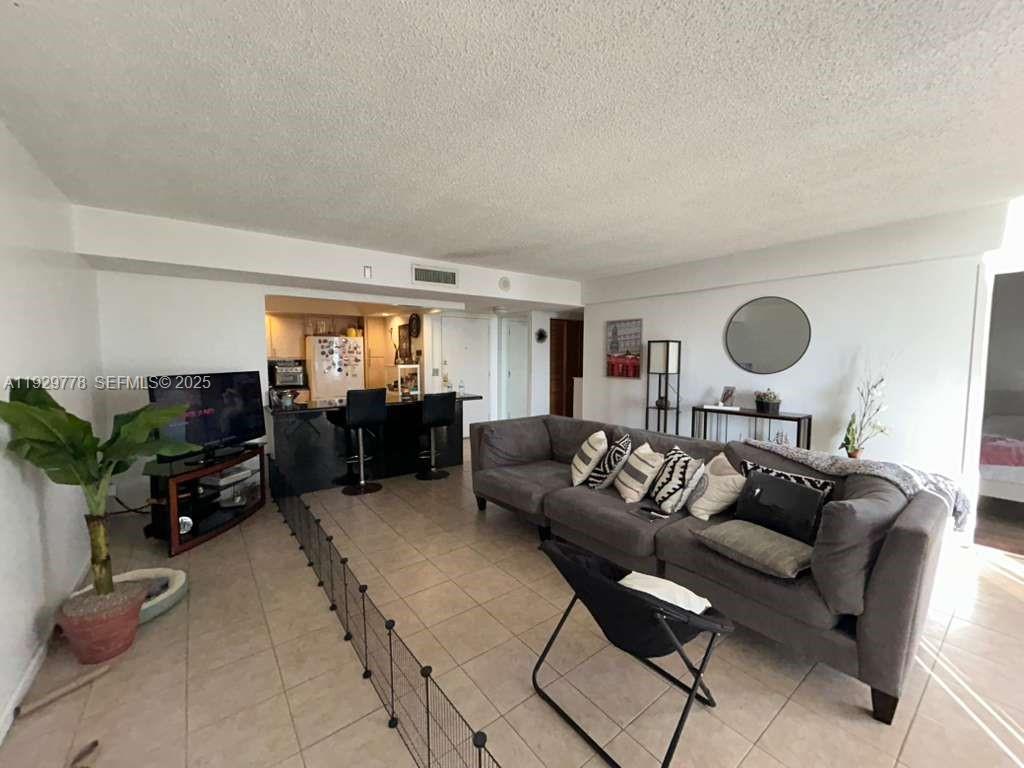 13499 Biscayne Boulevard, Unit 1206 North Miami, FL 33181 - Photo 8 of 20 a living room with furniture and a large window