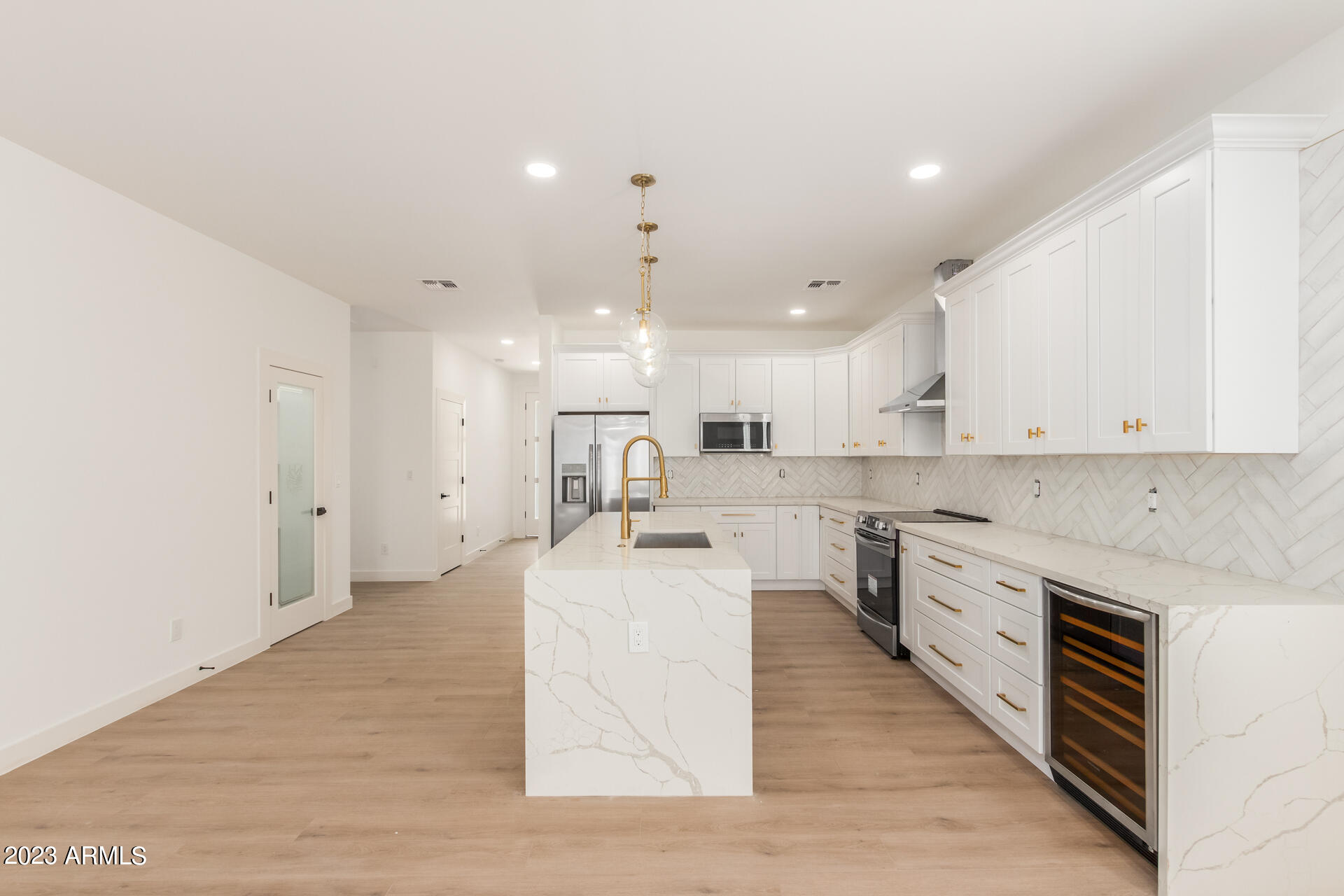 Undisclosed Address Phoenix, AZ 85014 - Photo 13 of 47 a large white kitchen with lots of counter space wooden floor and appliances