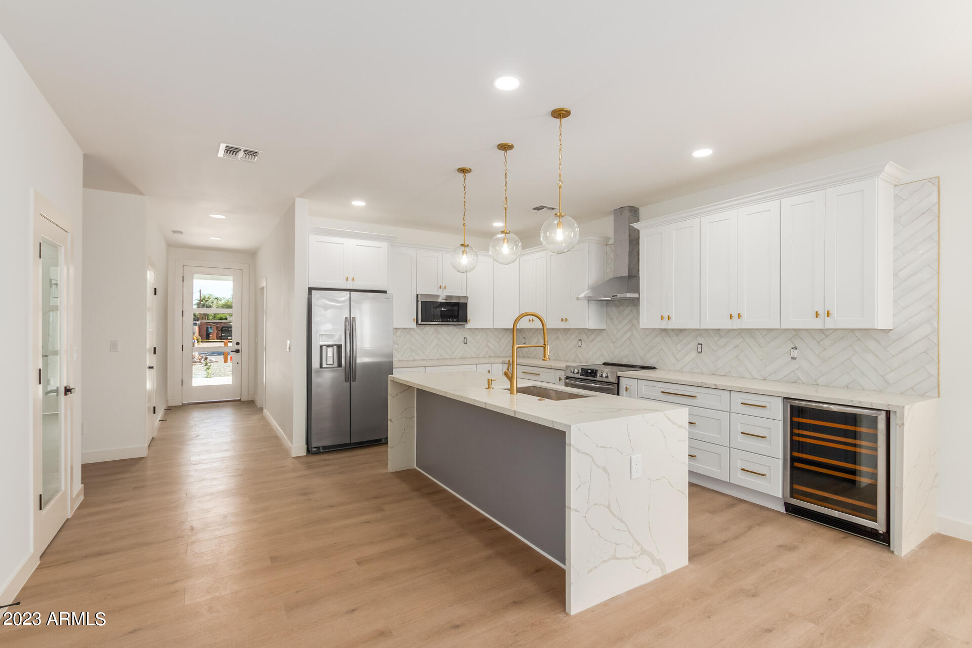Undisclosed Address Phoenix, AZ 85014 - Photo 14 of 47 a kitchen with stainless steel appliances kitchen island a sink a stove a refrigerator and white cabinets