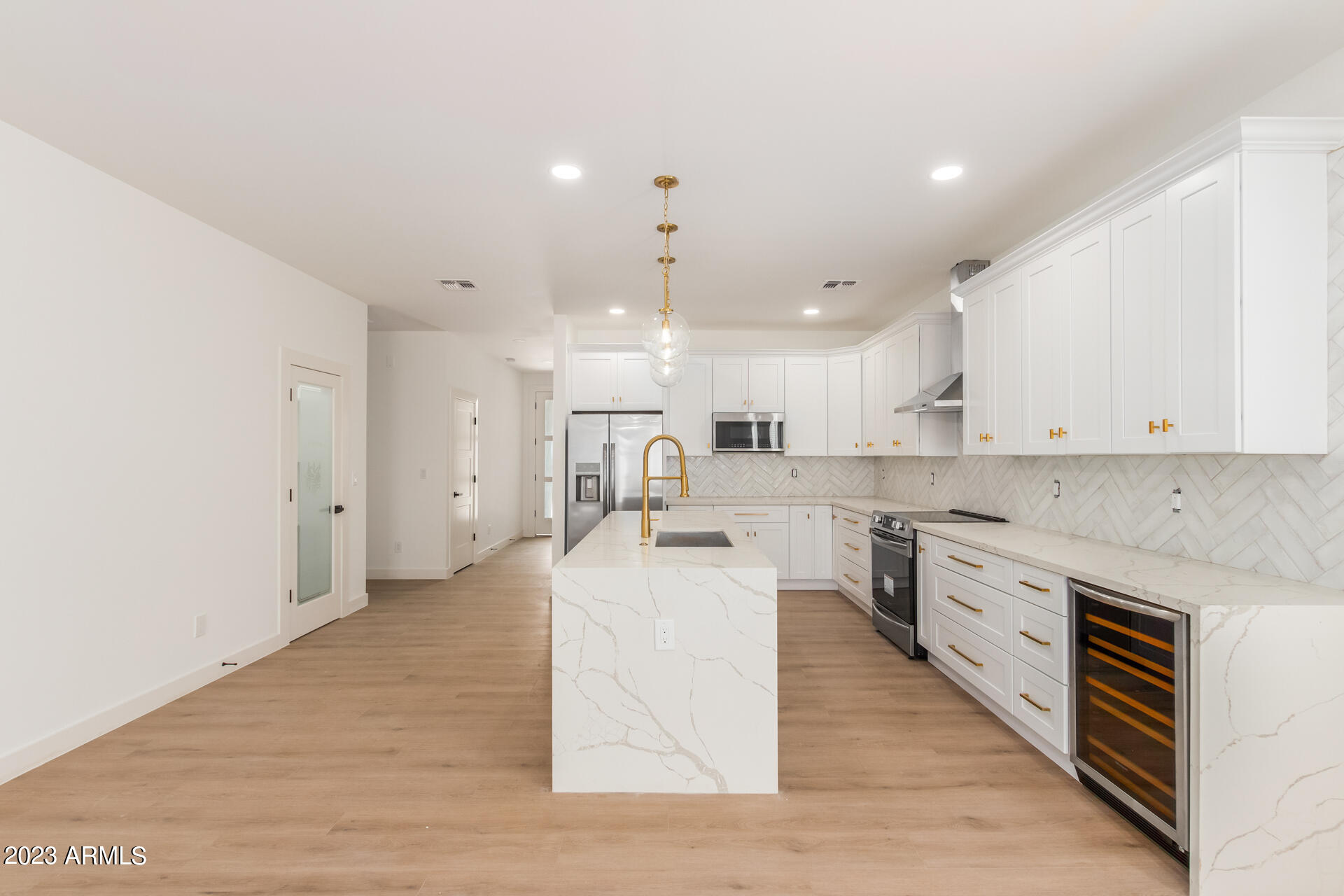 Undisclosed Address Phoenix, AZ 85014 - Photo 15 of 47 a large white kitchen with cabinets a sink and a stove