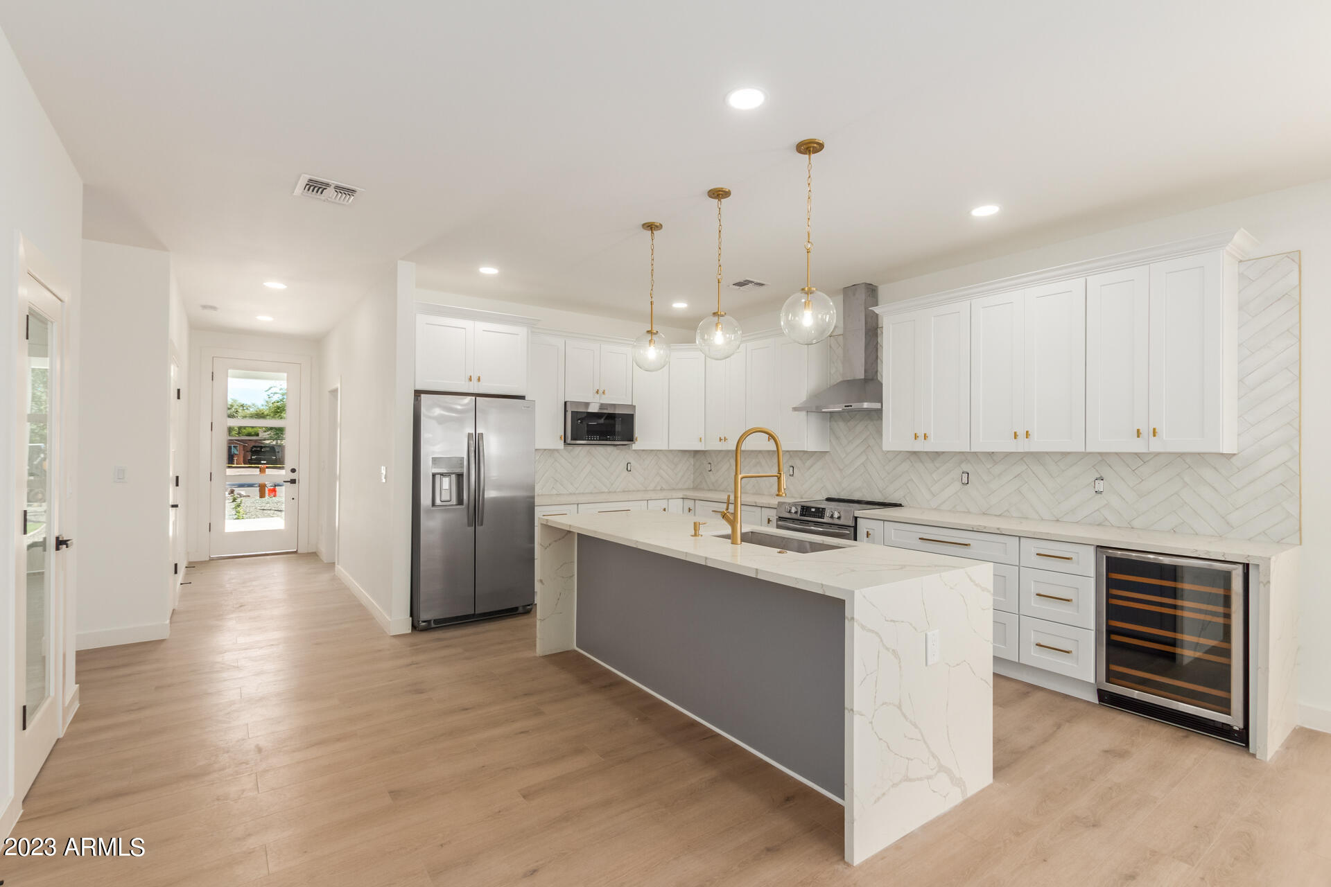 Undisclosed Address Phoenix, AZ 85014 - Photo 19 of 47 a kitchen with stainless steel appliances kitchen island a sink a stove a refrigerator and white cabinets