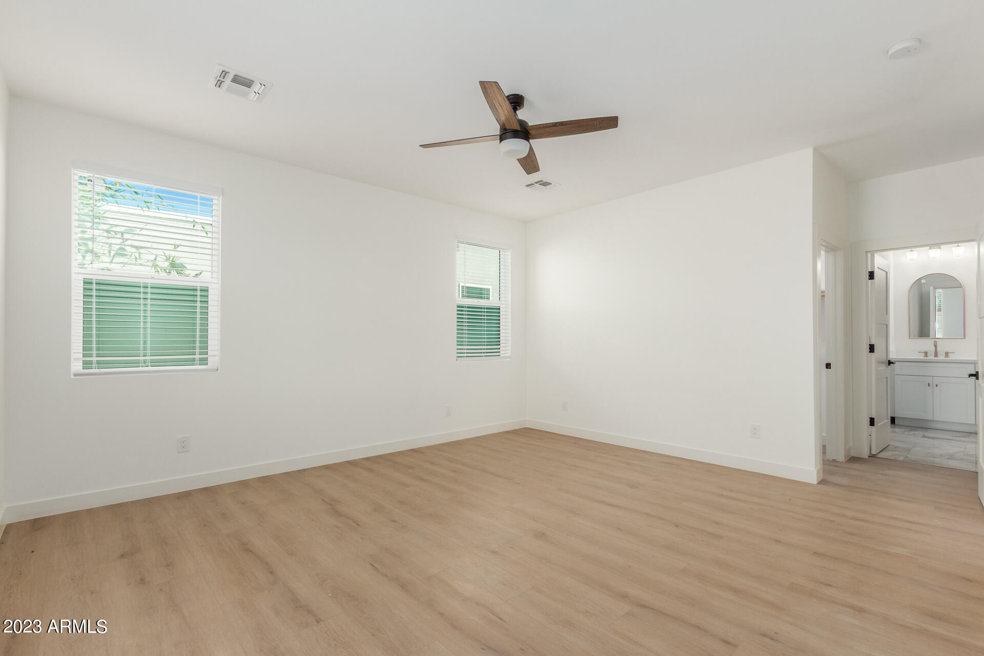 Undisclosed Address Phoenix, AZ 85014 - Photo 24 of 47 an empty room with a window and a ceiling fan