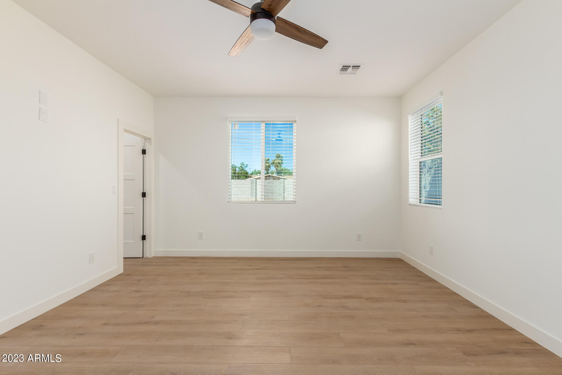 Undisclosed Address Phoenix, AZ 85014 - Photo 26 of 47 an empty room with a ceiling fan and window