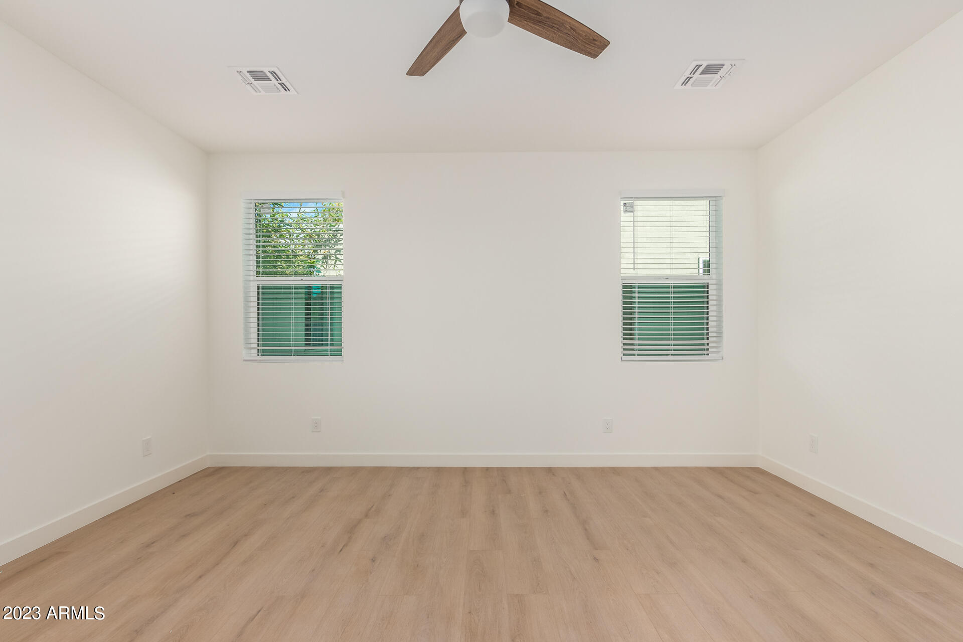 Undisclosed Address Phoenix, AZ 85014 - Photo 27 of 47 an empty room with a window and a ceiling fan