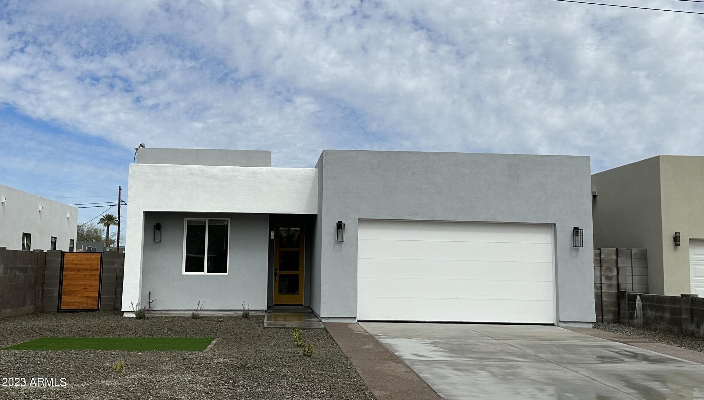 Undisclosed Address Phoenix, AZ 85014 - Photo 32 of 47 a front view of a house with a garage