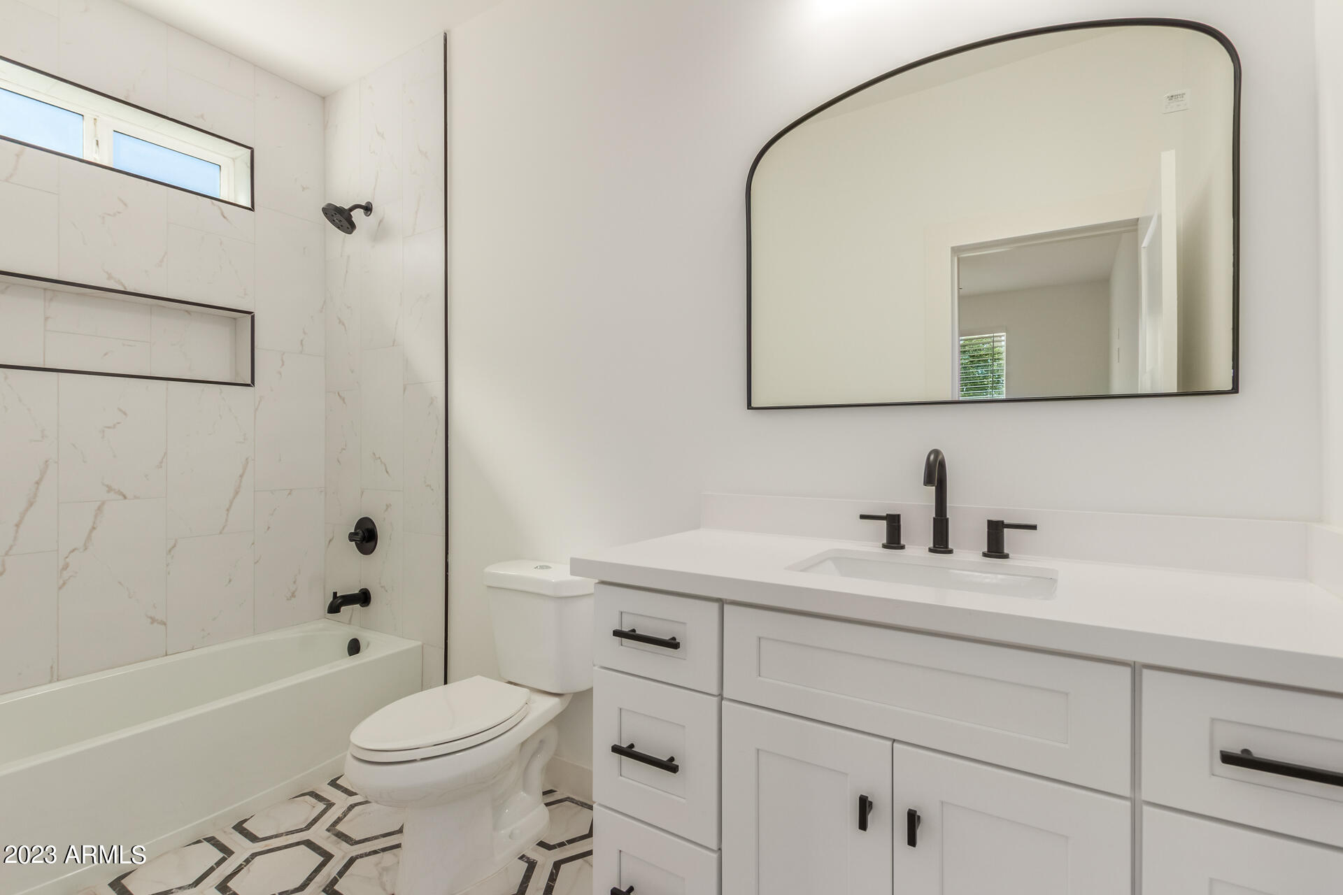 Undisclosed Address Phoenix, AZ 85014 - Photo 37 of 47 a bathroom with a toilet a sink a mirror a bathtub and vanity