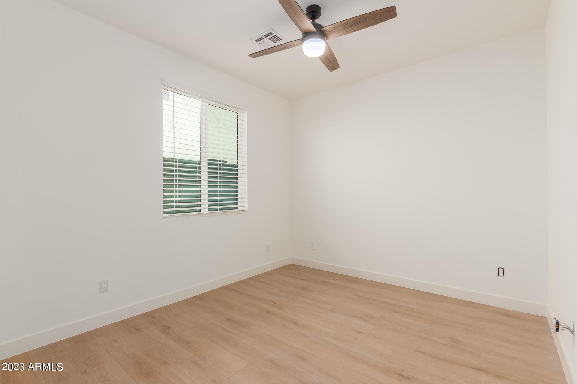Undisclosed Address Phoenix, AZ 85014 - Photo 38 of 47 an empty room with a window and ceiling fan