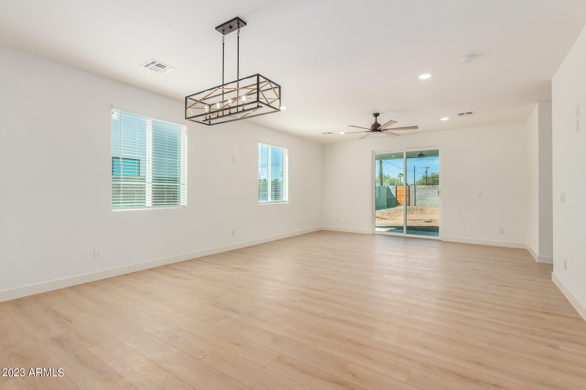 Undisclosed Address Phoenix, AZ 85014 - Photo 10 of 47 an empty room with windows and chandelier