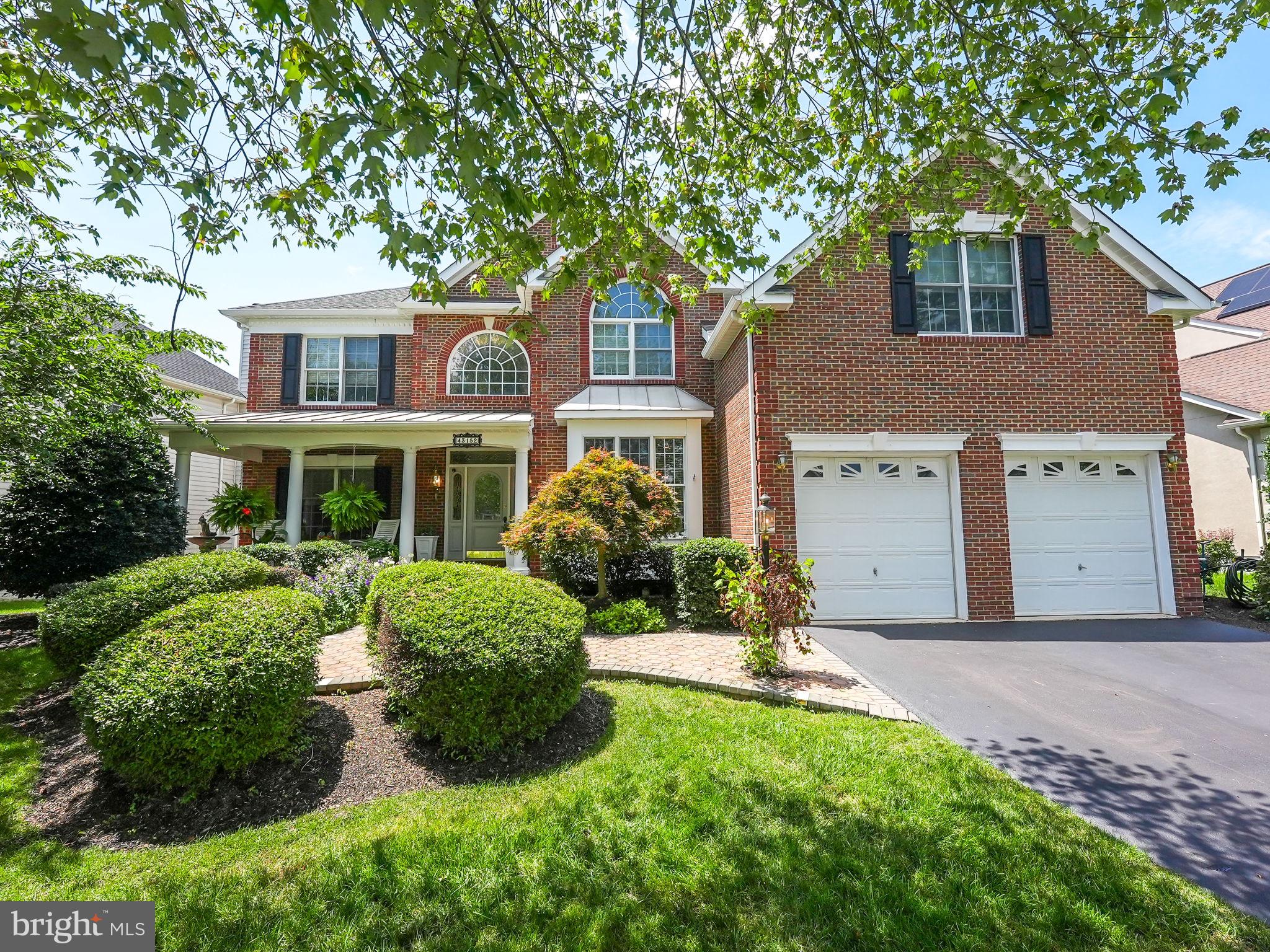 a front view of a house with a yard and porch