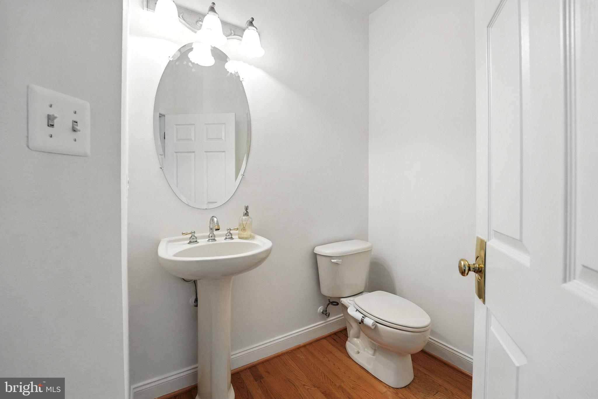 43152 Valiant Drive Chantilly, VA 20152 - Photo 16 of 44 a bathroom with a toilet a sink and a mirror