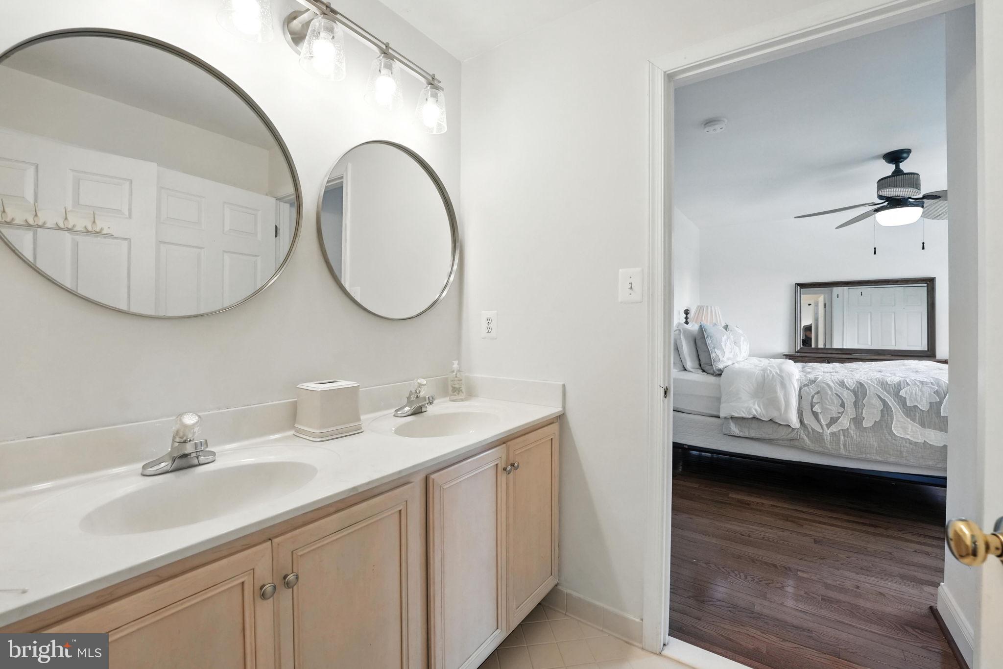 43152 Valiant Drive Chantilly, VA 20152 - Photo 21 of 44 a en suite bathroom with a double vanity sink and a mirror