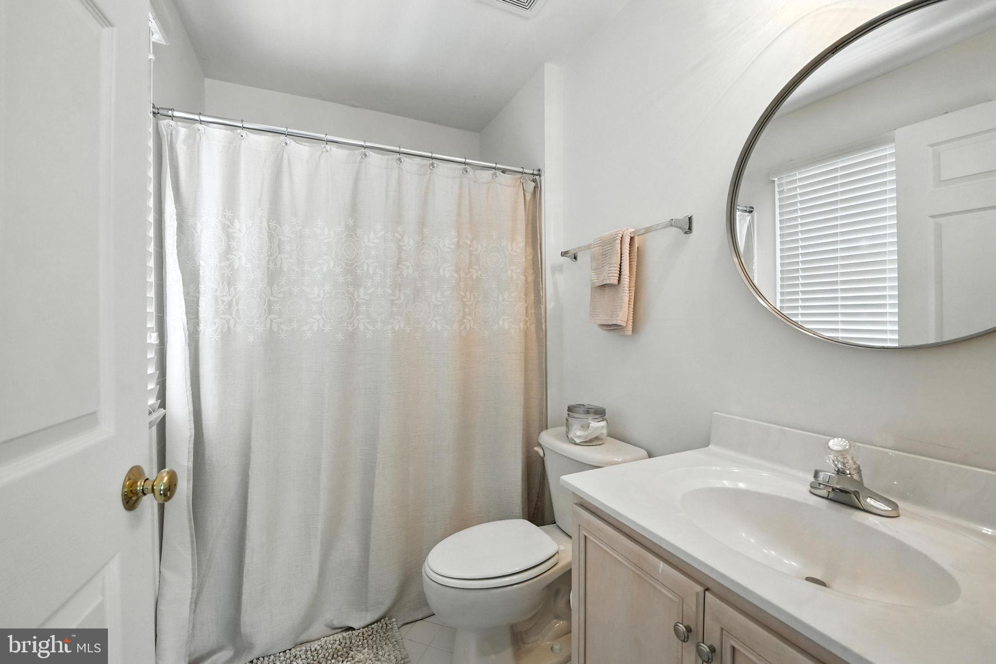 43152 Valiant Drive Chantilly, VA 20152 - Photo 24 of 44 a bathroom with a granite countertop sink and a mirror