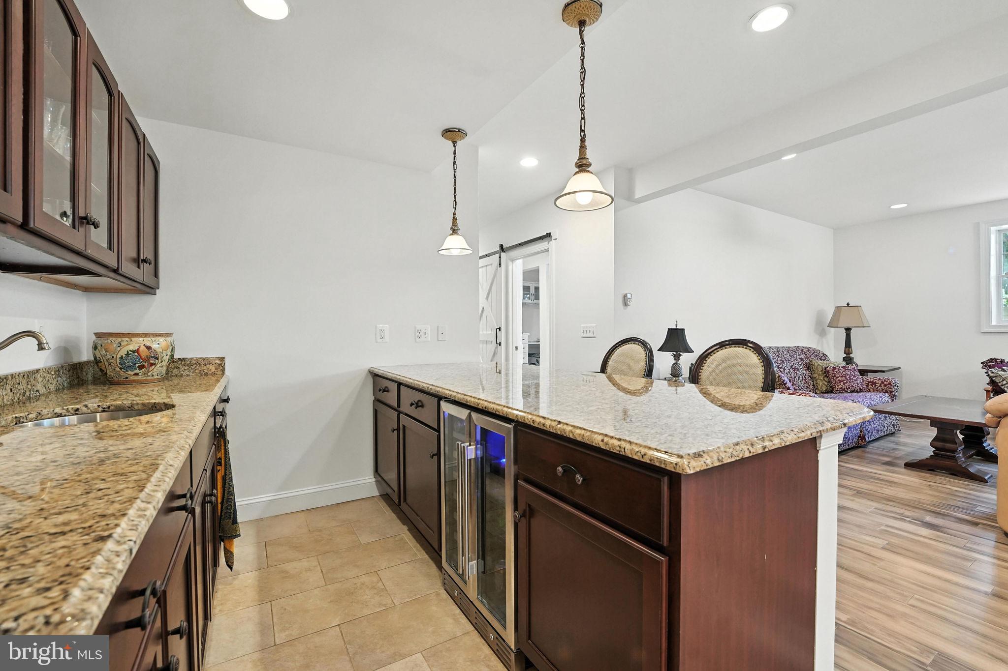 43152 Valiant Drive Chantilly, VA 20152 - Photo 29 of 44 a kitchen with stainless steel appliances granite countertop a sink a stove and a wooden floor